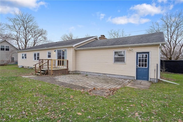 back of property featuring a patio area and a yard