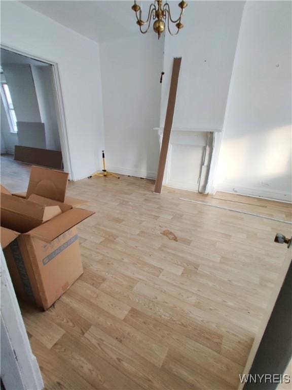 508 Howard St, Buffalo, NY 14206 - unfurnished living room with a chandelier and light wood-style floors