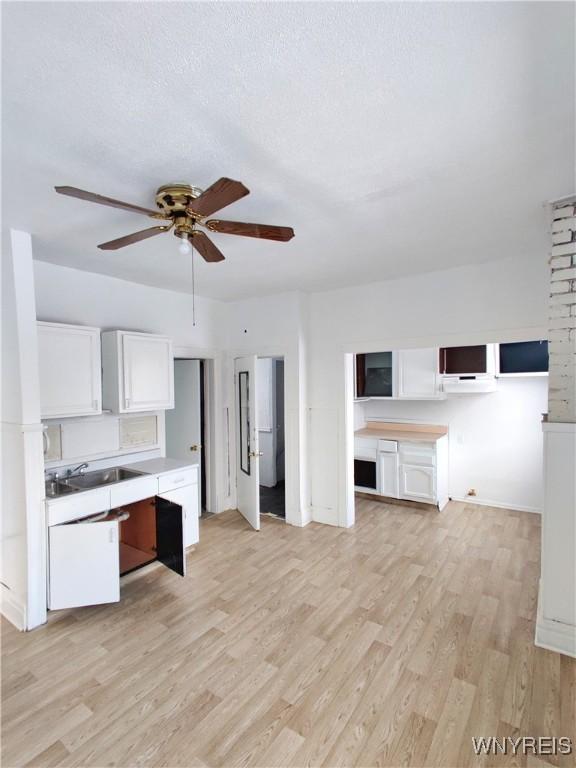 508 Howard St, Buffalo, NY 14206 - kitchen with a ceiling fan, light wood-type flooring, white cabinetry, and light countertops