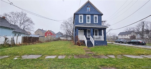 view of front facade featuring covered porch and a front lawn