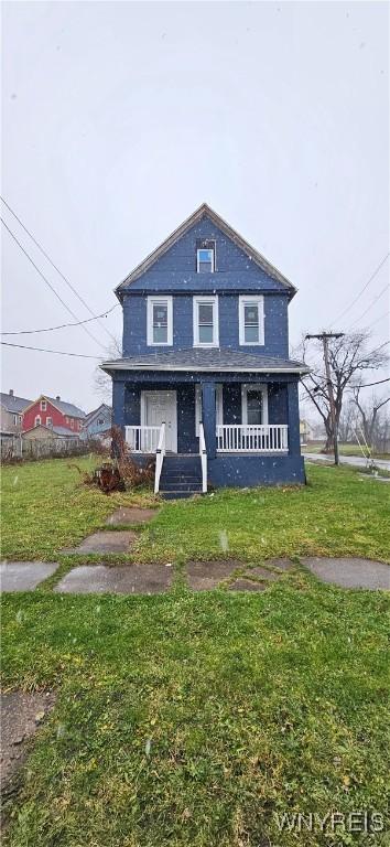 front of property featuring a porch and a front yard