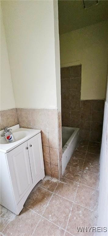 bathroom with vanity, a shower, and tile walls