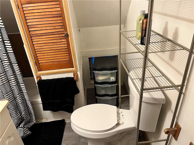 bathroom featuring shower / bath combo, hardwood / wood-style flooring, and toilet