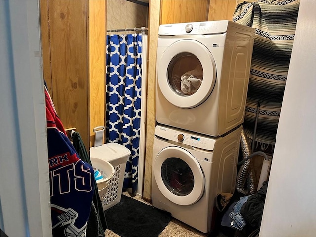 laundry area with stacked washing maching and dryer