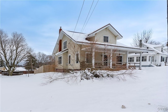 snow covered house with covered porch