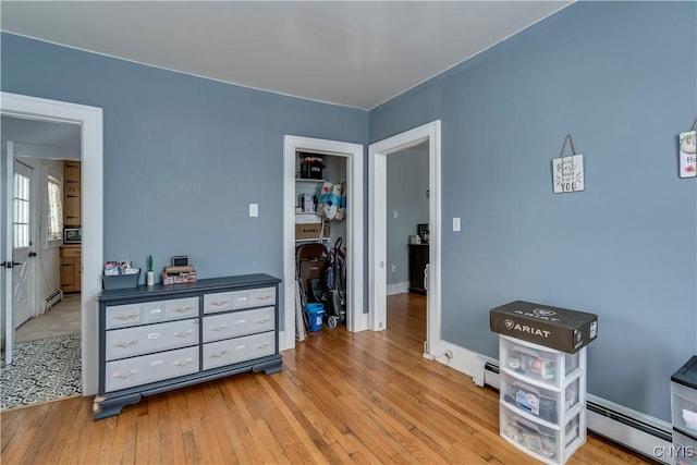 interior space featuring light wood-type flooring and a baseboard radiator