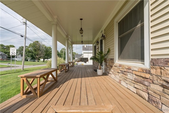 deck with a lawn and covered porch