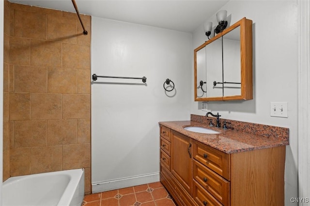 bathroom with tile patterned flooring, vanity, and tiled shower / bath