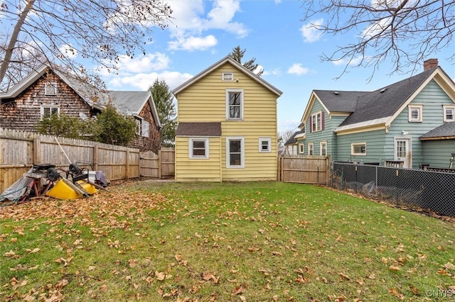 rear view of property featuring a yard