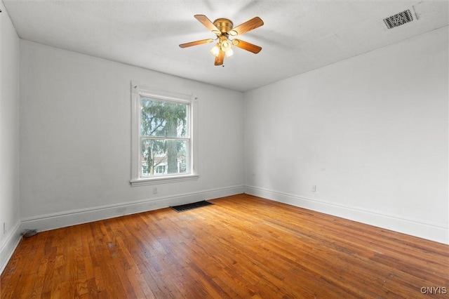 spare room with ceiling fan and wood-type flooring