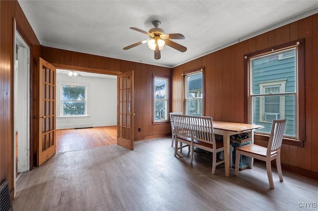 dining room featuring ceiling fan, french doors, ornamental molding, and hardwood / wood-style flooring