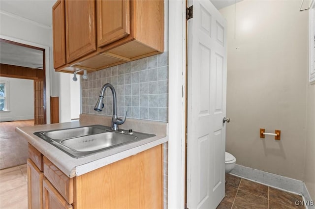 kitchen featuring tile patterned flooring, tasteful backsplash, and sink