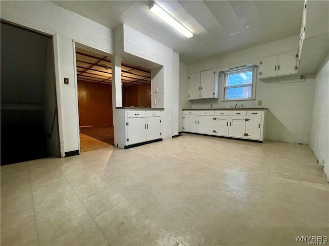 kitchen featuring white cabinetry and sink