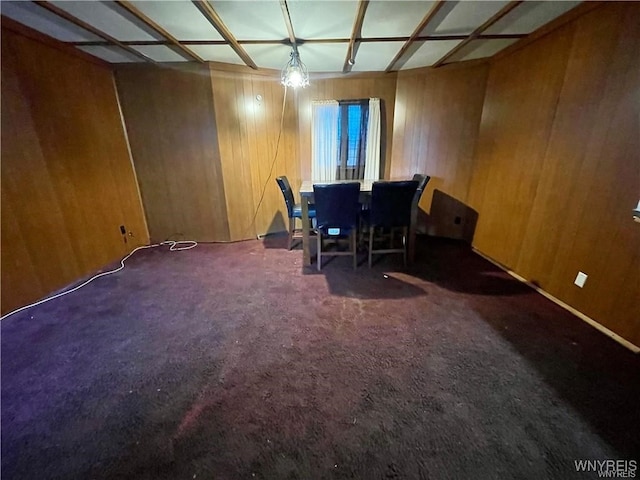 carpeted office with wooden walls and coffered ceiling