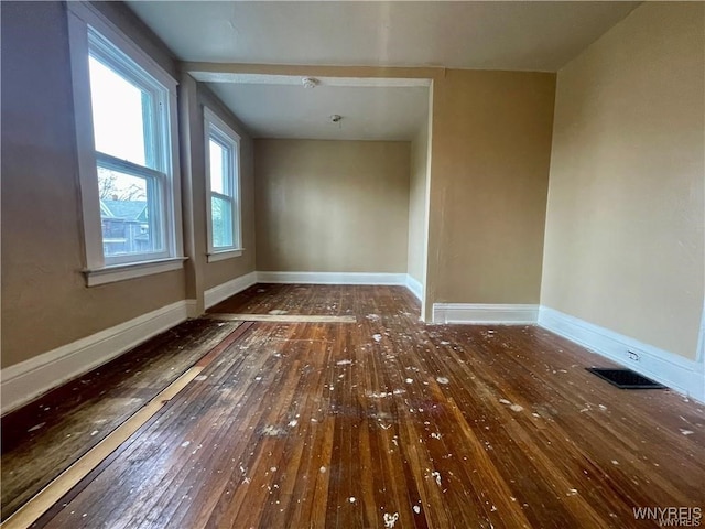 unfurnished room with dark hardwood / wood-style flooring