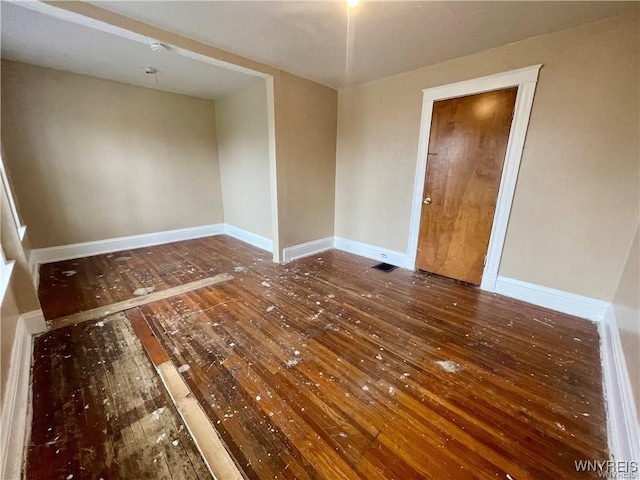 spare room with dark wood-type flooring