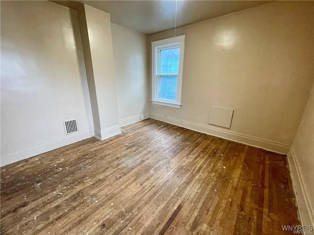 empty room featuring dark hardwood / wood-style flooring