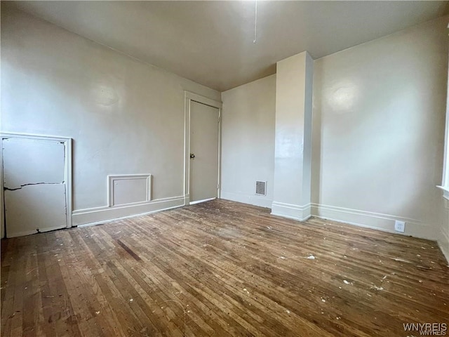 spare room with wood-type flooring