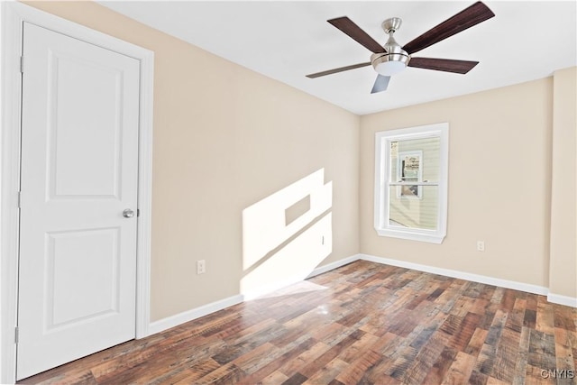 unfurnished room with dark hardwood / wood-style flooring and ceiling fan