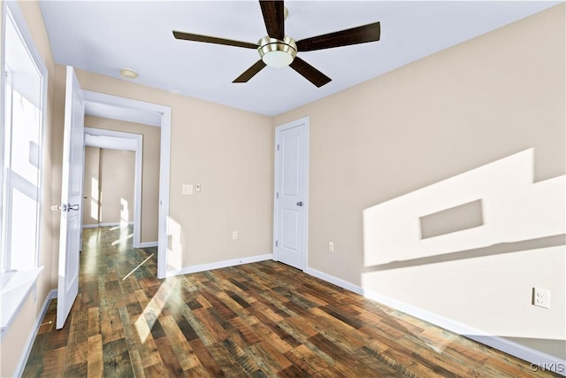 unfurnished room featuring dark hardwood / wood-style floors and ceiling fan