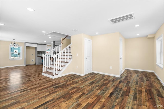 unfurnished living room with dark wood-type flooring