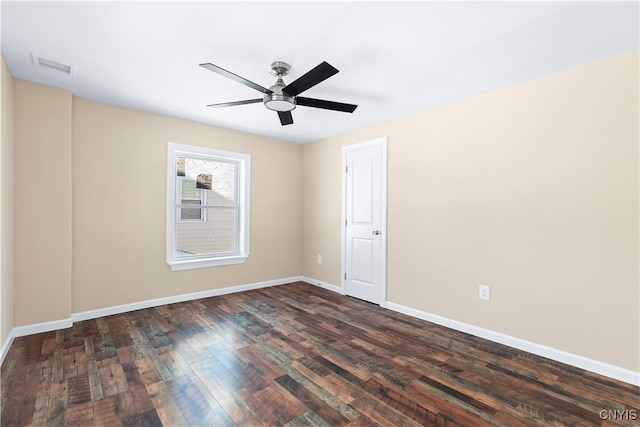 empty room with ceiling fan and dark wood-type flooring