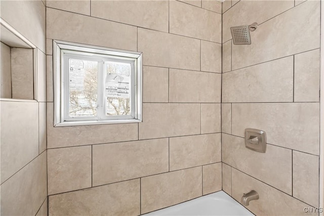 interior details featuring tiled shower / bath combo