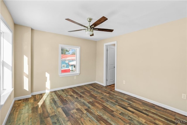 unfurnished room featuring ceiling fan and dark hardwood / wood-style flooring