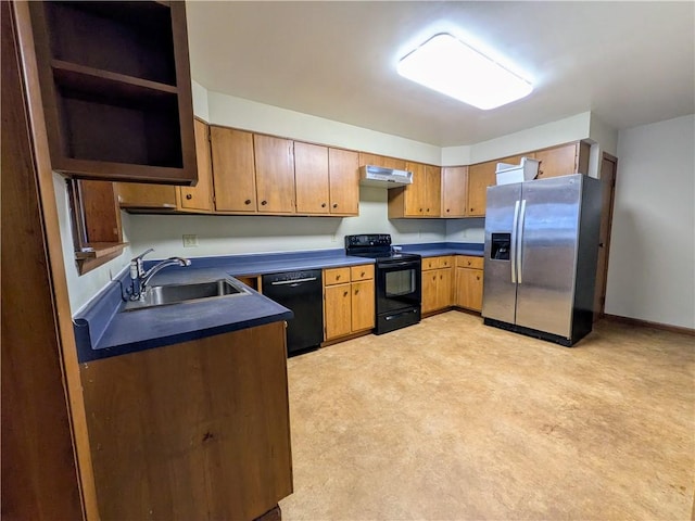 kitchen featuring black appliances, sink, and light carpet