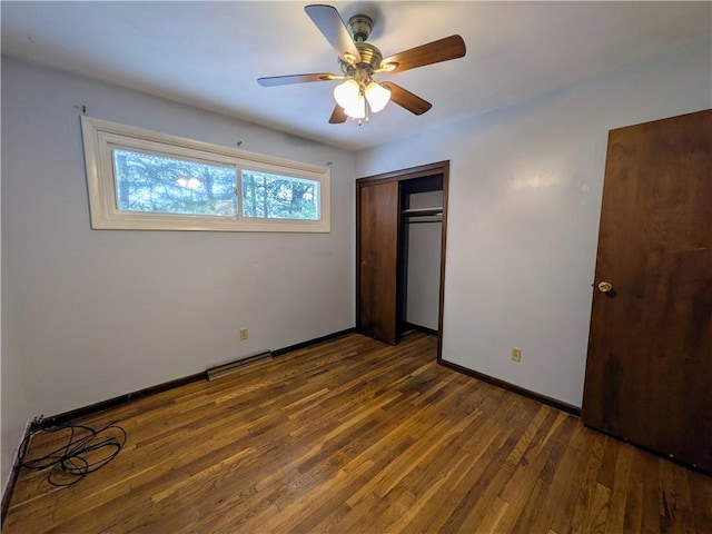 unfurnished bedroom featuring ceiling fan, a closet, and dark hardwood / wood-style floors