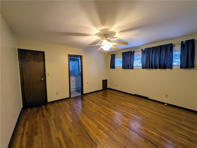 empty room with ceiling fan and hardwood / wood-style floors