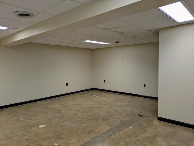 basement with a paneled ceiling