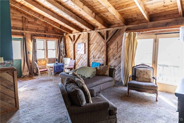 carpeted living room featuring wooden walls, lofted ceiling with beams, and wooden ceiling