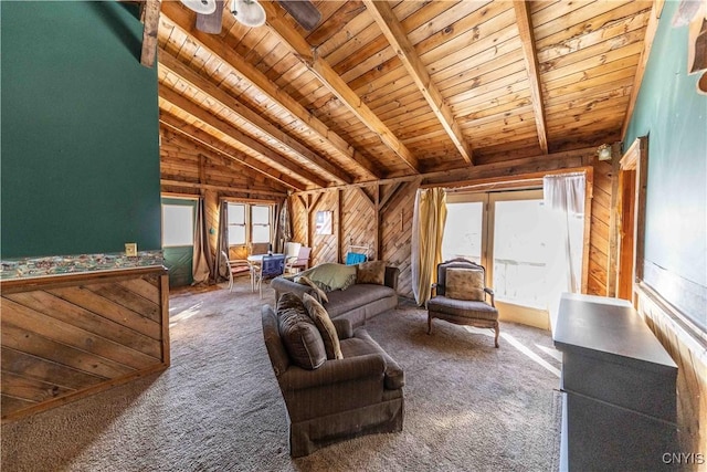 living area with wooden walls, wooden ceiling, lofted ceiling with beams, and carpet