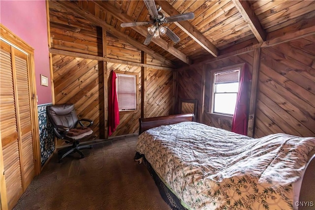 unfurnished bedroom featuring lofted ceiling with beams, dark carpet, wood ceiling, and wooden walls