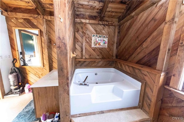 bathroom featuring wood ceiling, a bathtub, and wood walls