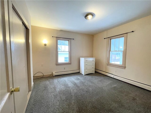 unfurnished bedroom featuring a closet, carpet, and a baseboard radiator