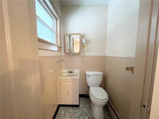 bathroom featuring vanity, toilet, and tile walls