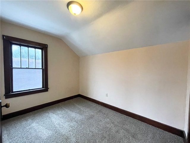 bonus room with carpet and vaulted ceiling