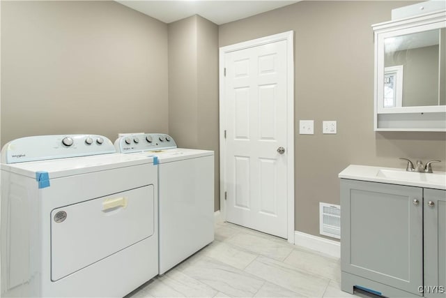 laundry room featuring washing machine and dryer and sink