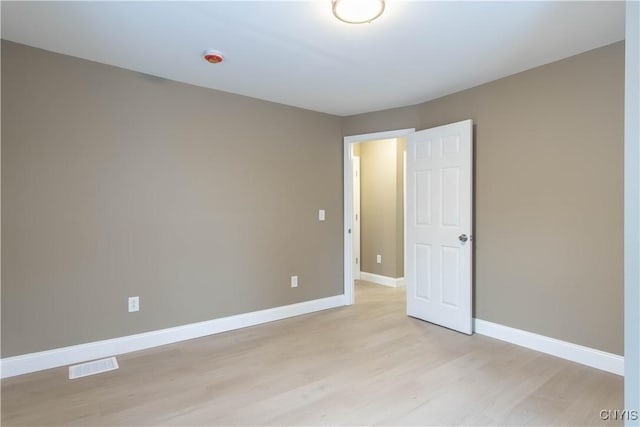 empty room with light hardwood / wood-style flooring