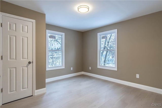 empty room featuring light hardwood / wood-style flooring and a healthy amount of sunlight