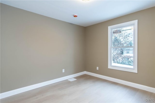 spare room with light hardwood / wood-style flooring