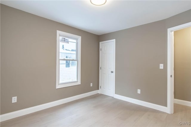 unfurnished room with light wood-type flooring