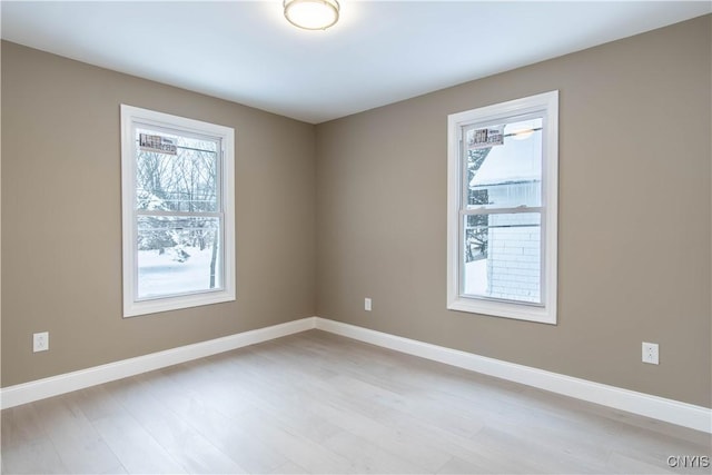 spare room with light hardwood / wood-style flooring