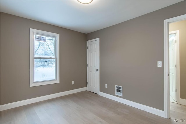 empty room with light hardwood / wood-style flooring