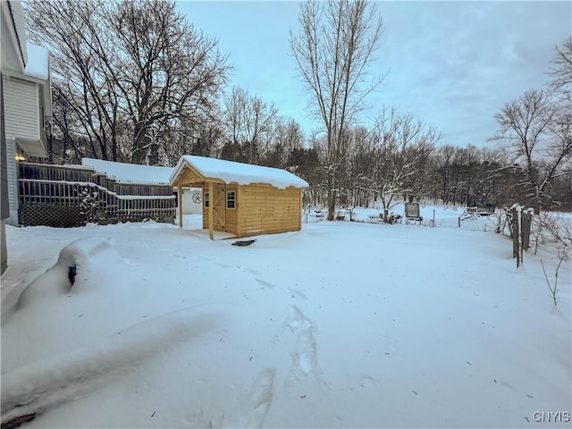 yard covered in snow featuring an outdoor structure