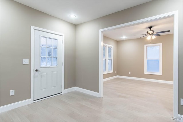 foyer featuring light wood-type flooring and ceiling fan