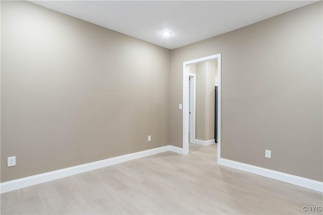 spare room featuring light hardwood / wood-style flooring