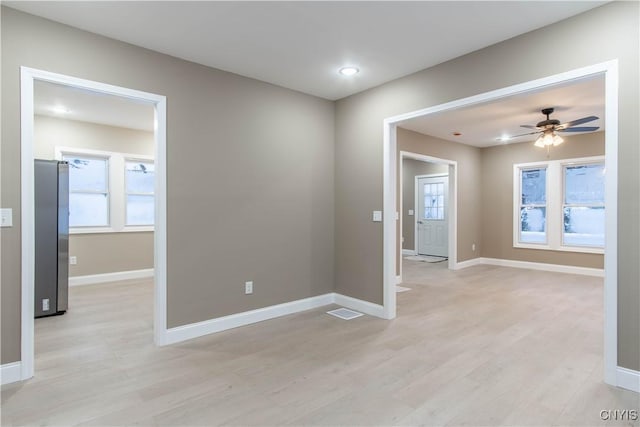 unfurnished room featuring light wood-type flooring and ceiling fan